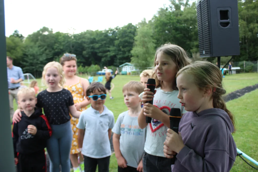 DBS article photo of children singing on karaoke